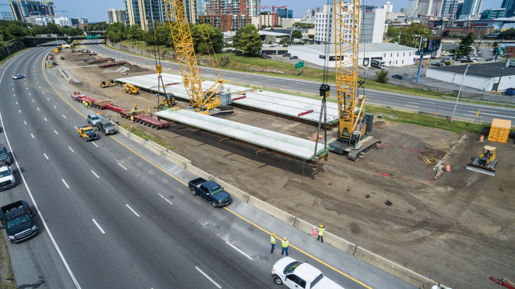 Equipment in the south yard picks panels for the Herman Street westbound bridge replacement. From there, they’re set on a self-propelled modular transport that carries them to the actual bridge location, 1 ½ miles north of the prefabrication area.