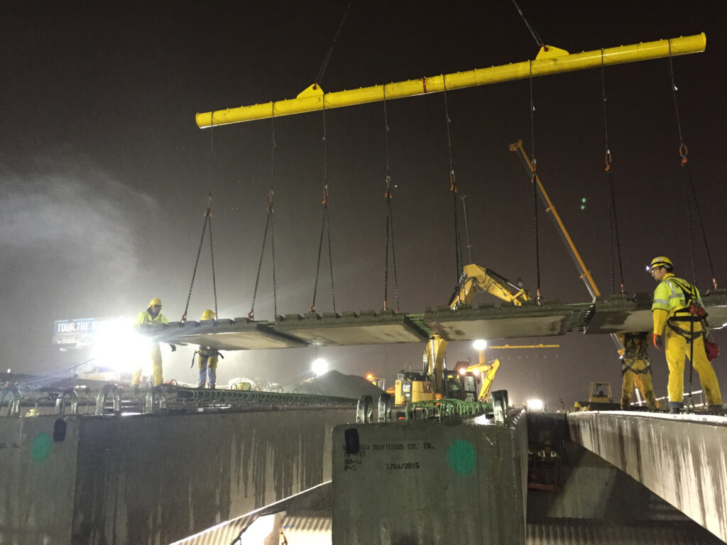 Precast concrete deck panels are flown into place over the CSX railroad during a weekend closure.