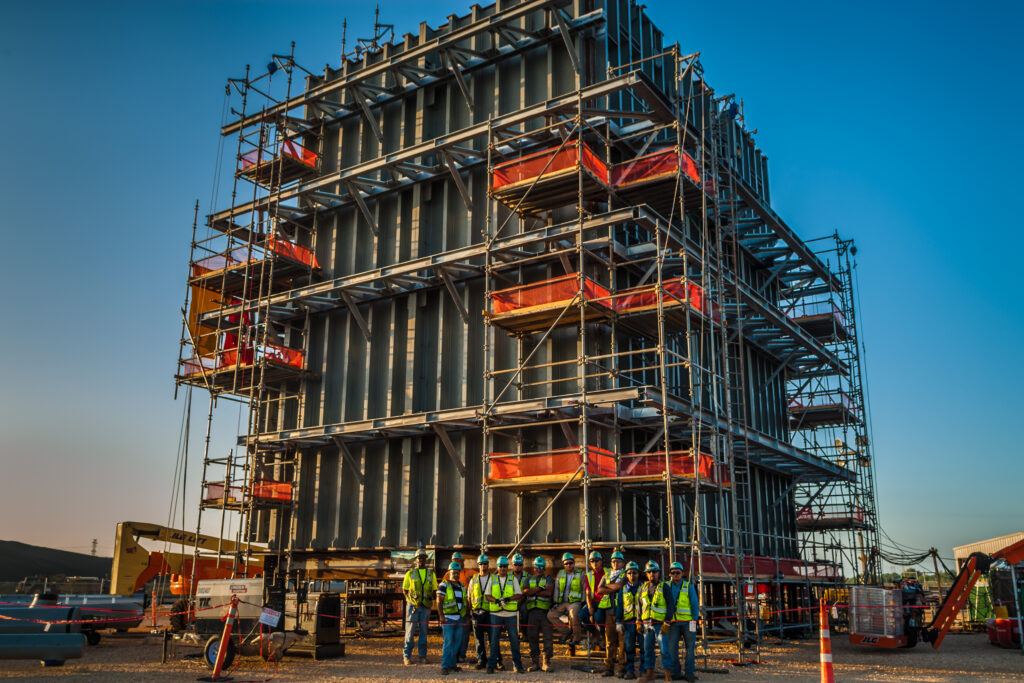 Increased productivity was achieved by constructing sections of the cooling tower in a nearby laydown yard and then using a platform trailer and crane to set in place.