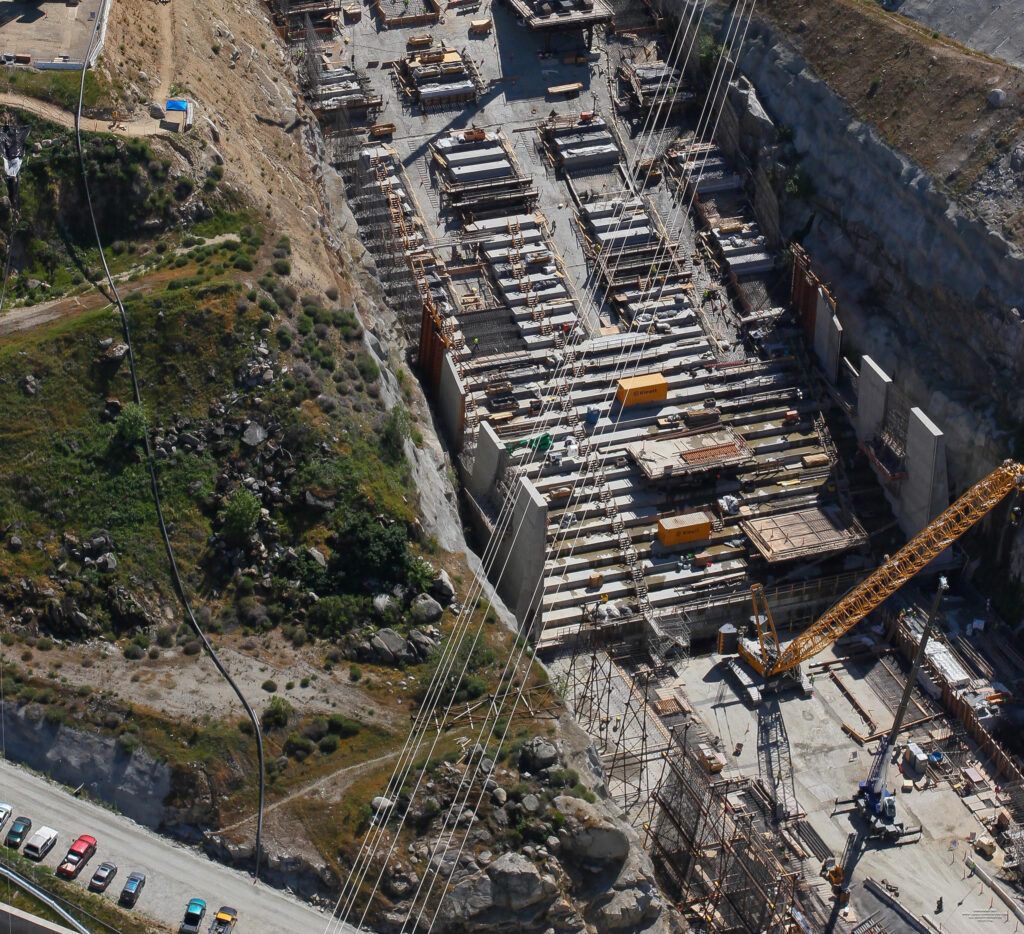 Step chute: Dropping water over 160 feet in elevation, the structure is stepped to help dissipate the energy of the water coming downhill. A special concrete mix is used to prevent scouring and erosion.