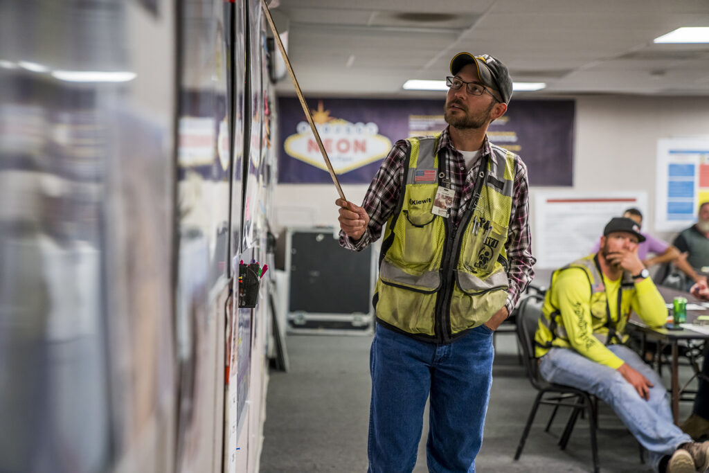 Planning Manager Chris Miske walks  through the next day's planned work at the  Play of the Day meeting. 