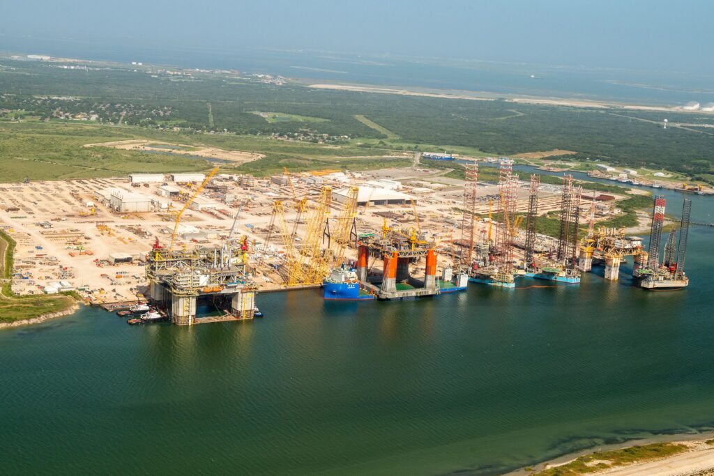 Image aérienne de Kiewit Offshore Services comprenant trois grandes installations pétrolières en surface en cours de fabrication