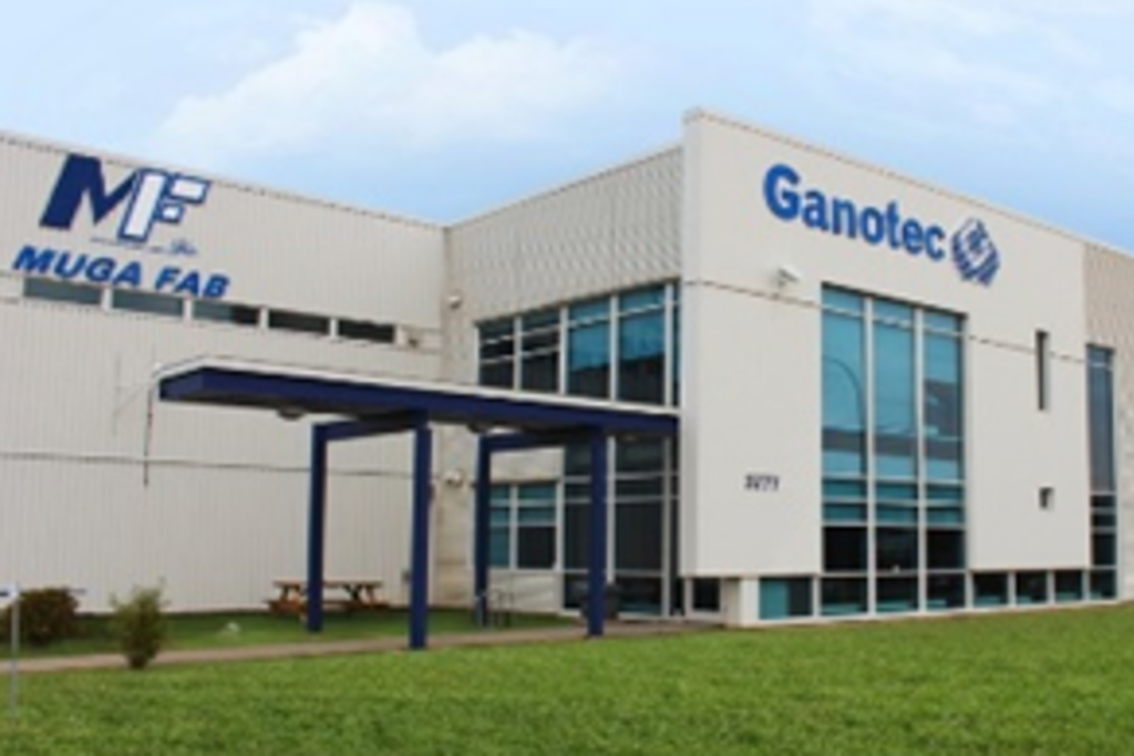 Exterior image of the Muga Fab facility with a blue Ganotec logo on the buiding