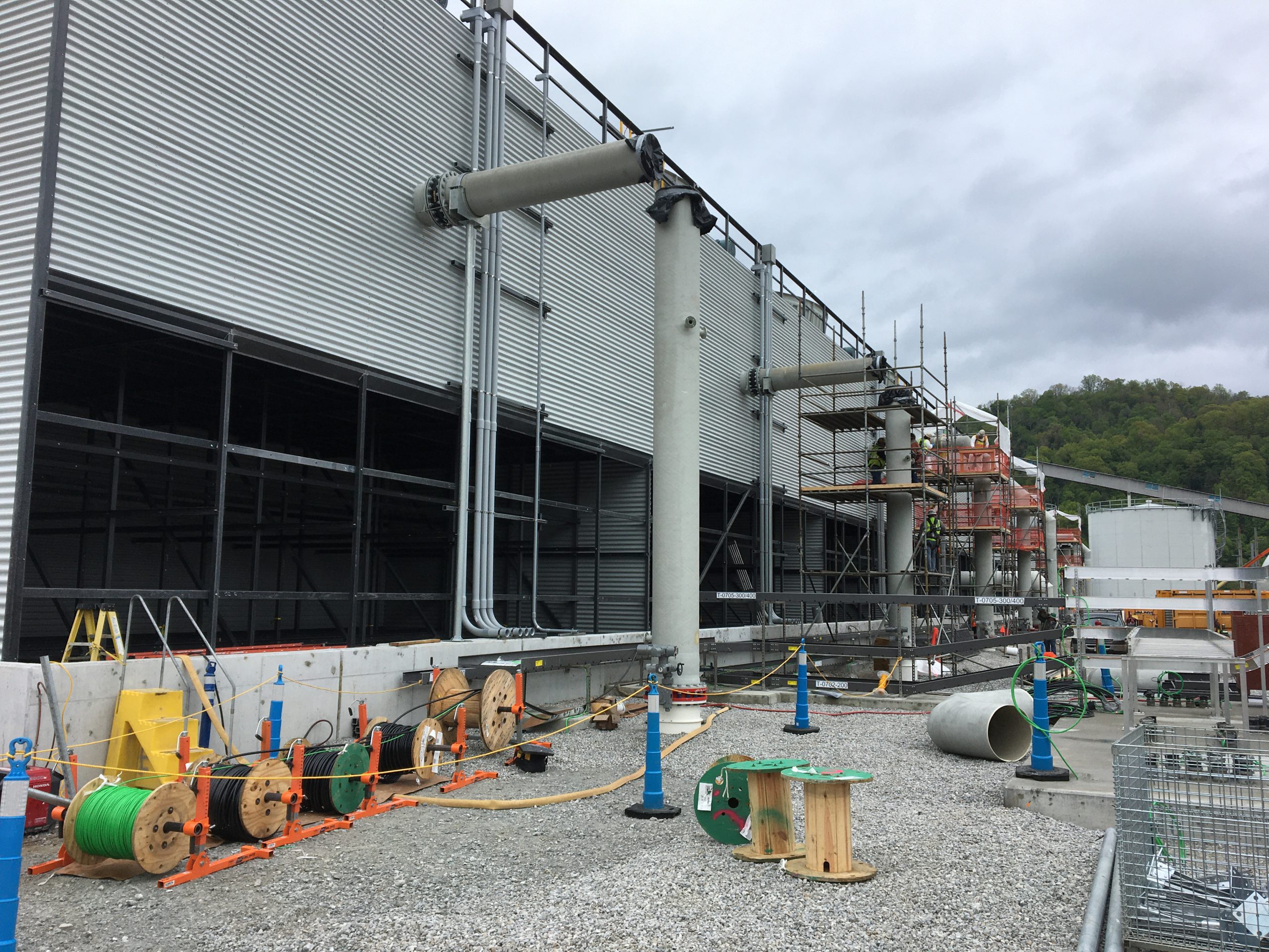 Cable pull operations are set up along the cooling tower.  