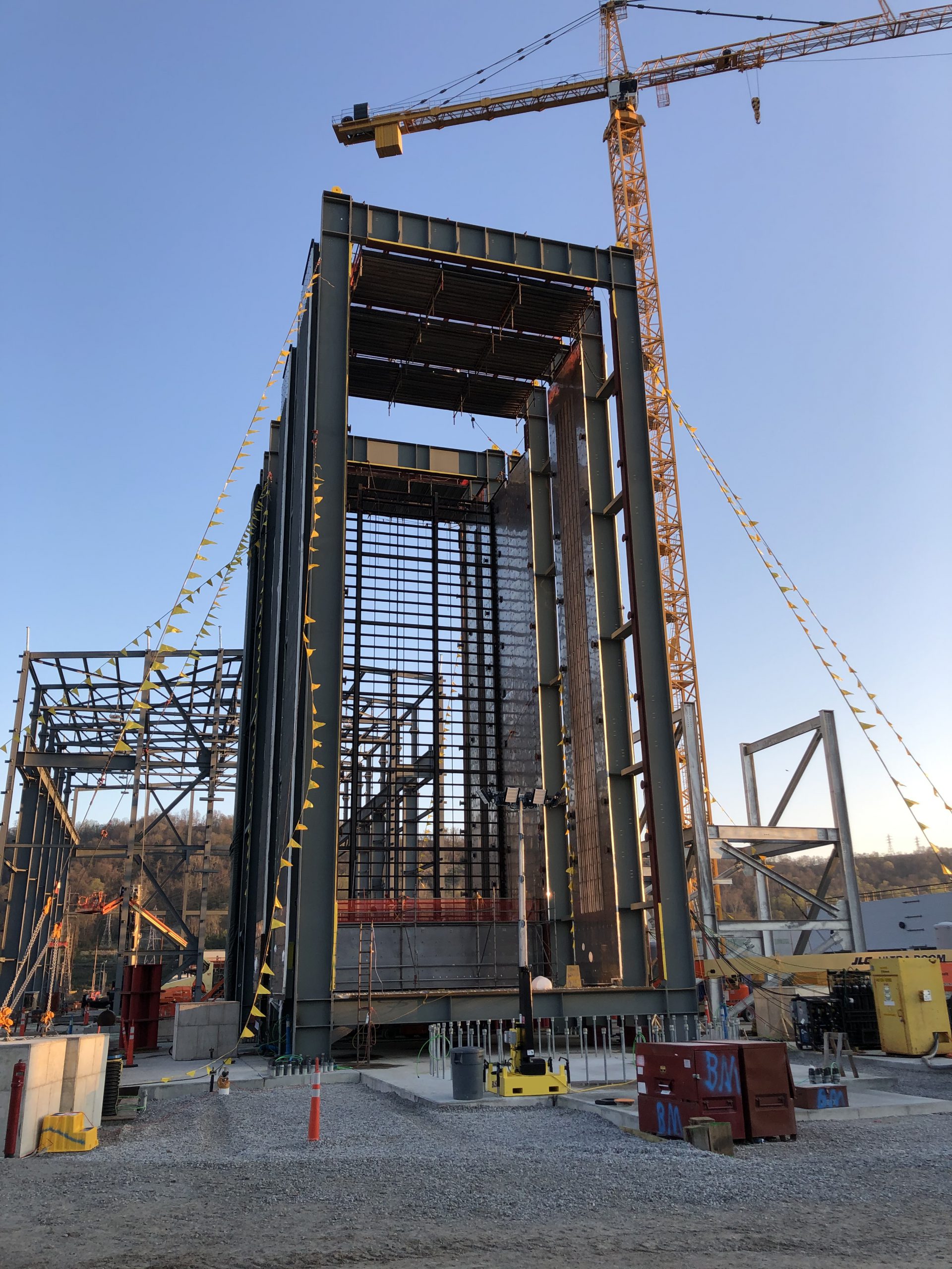 The Heat Recovery Steam Generator casing is shown near completion.