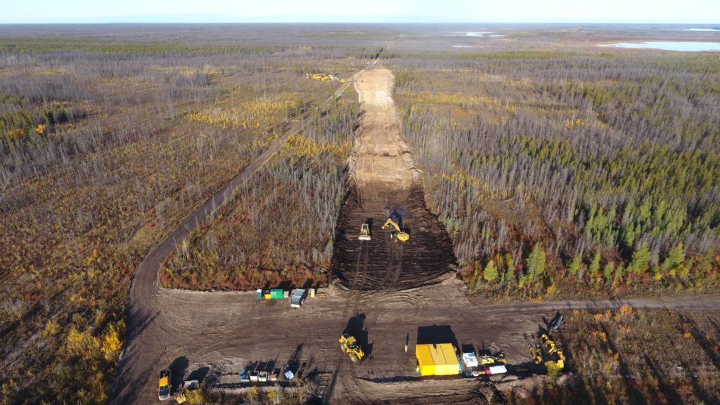 Crews cut a path for the new road through dense vegetation.
