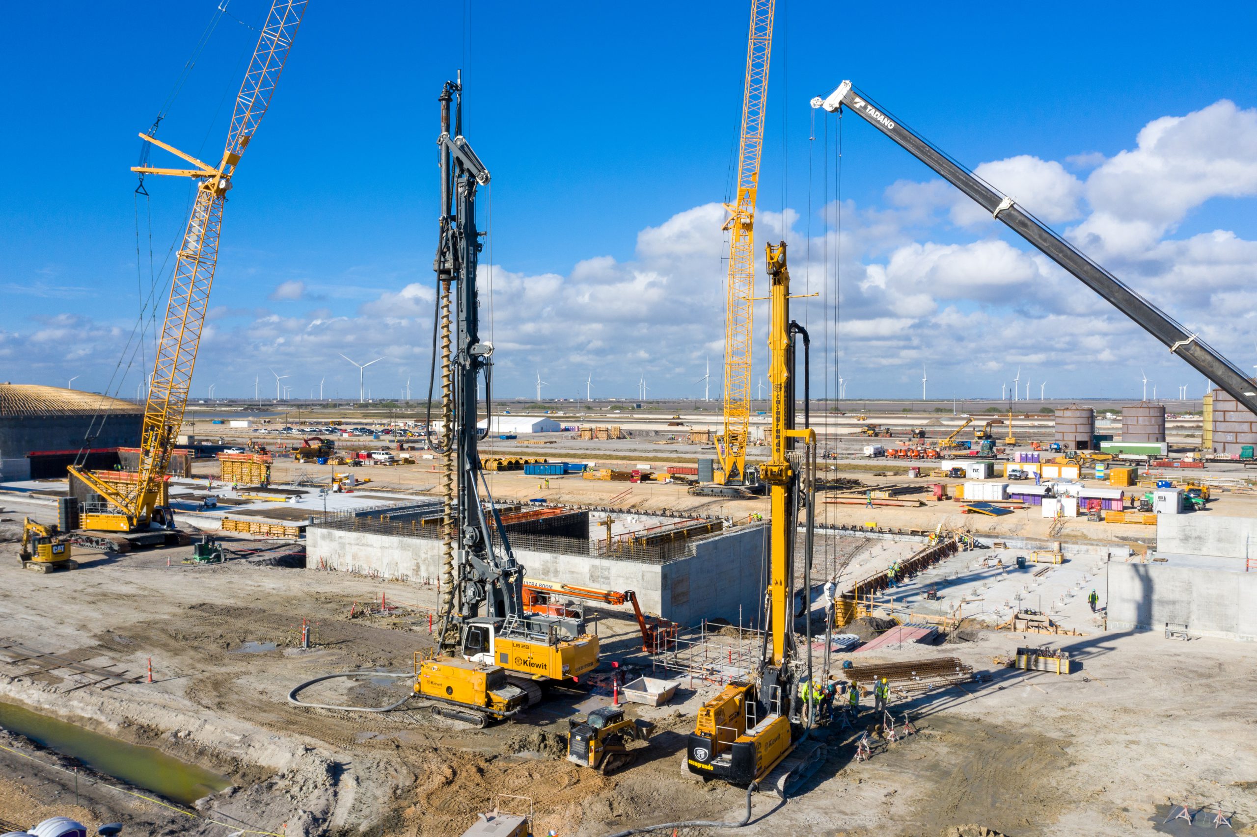 Crews transform a cotton field to a level-stabilized surface in preparation of setting the “plug and play” modules being fabricated overseas. 