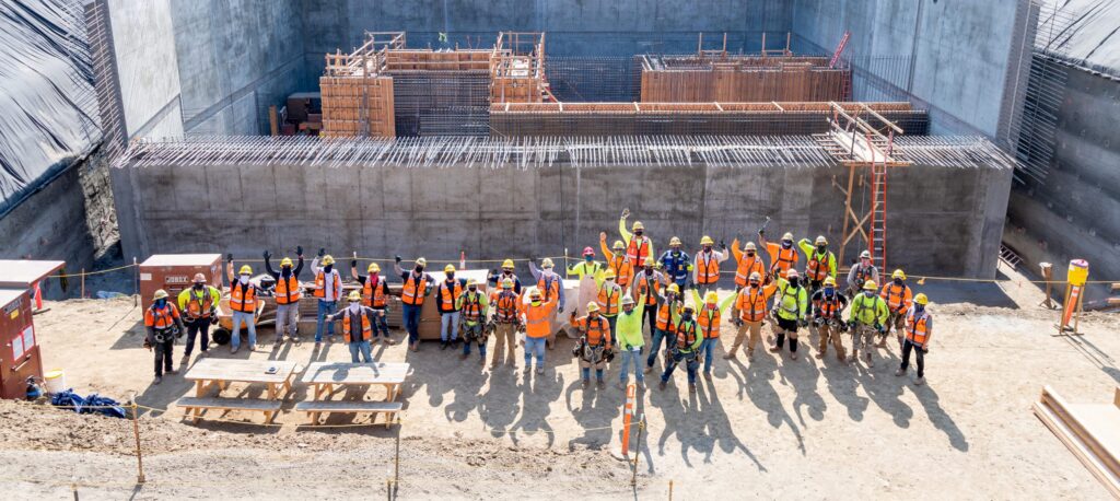 The SWIP team stands in the 1.5 million gallon stormwater capture tank for a photo.