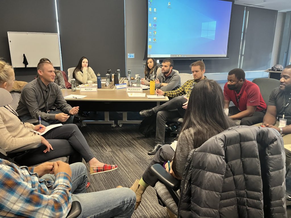 Kiewit employees interact at a live training session in Omaha, Nebraska. The session is part of Kiewit's new NextGen hybrid training model designed to prepare future project leaders.