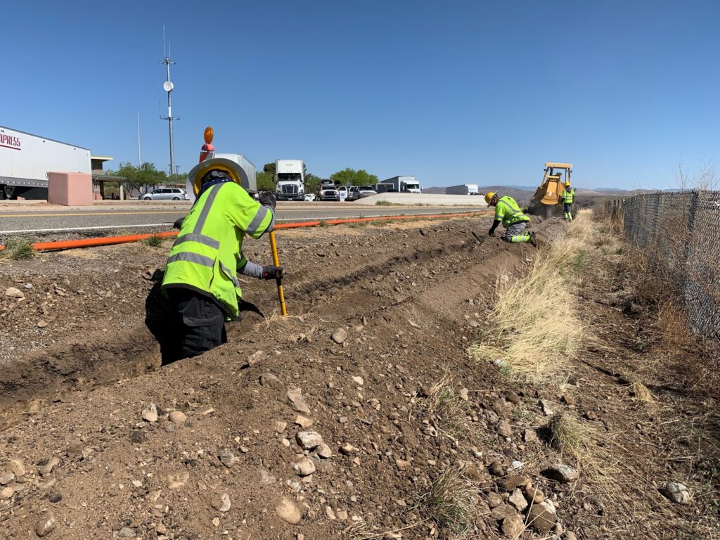 Crews use a rocksaw trencher and actively check the depth of the trench prior to placing the conduit.