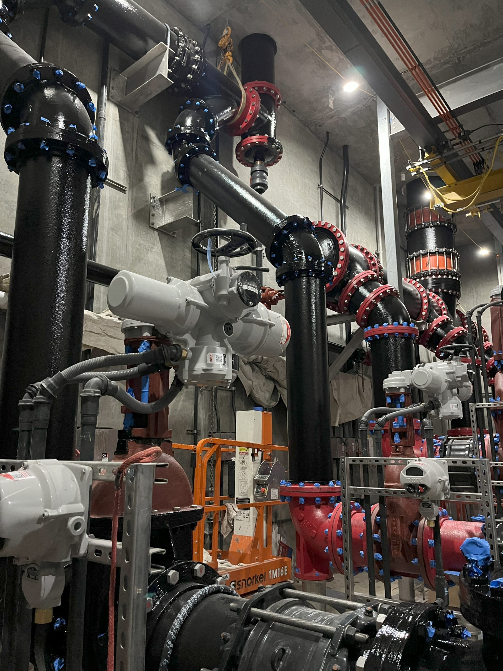At the Ballona Creek facility, pumps draw water from the wet well and distribute it through two separate flow paths. One header routes water vertically through the roof to the ozone disinfection system, while the other directs flow to the Hyperion Water Reclamation Plant via a bypass line.