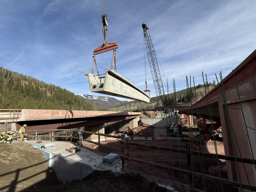 Crew members place a tub girder for the new bridge. Its tub-shaped design provides the strength needed to resist bending and twisting forces, helping support the bridge under years of heavy traffic.